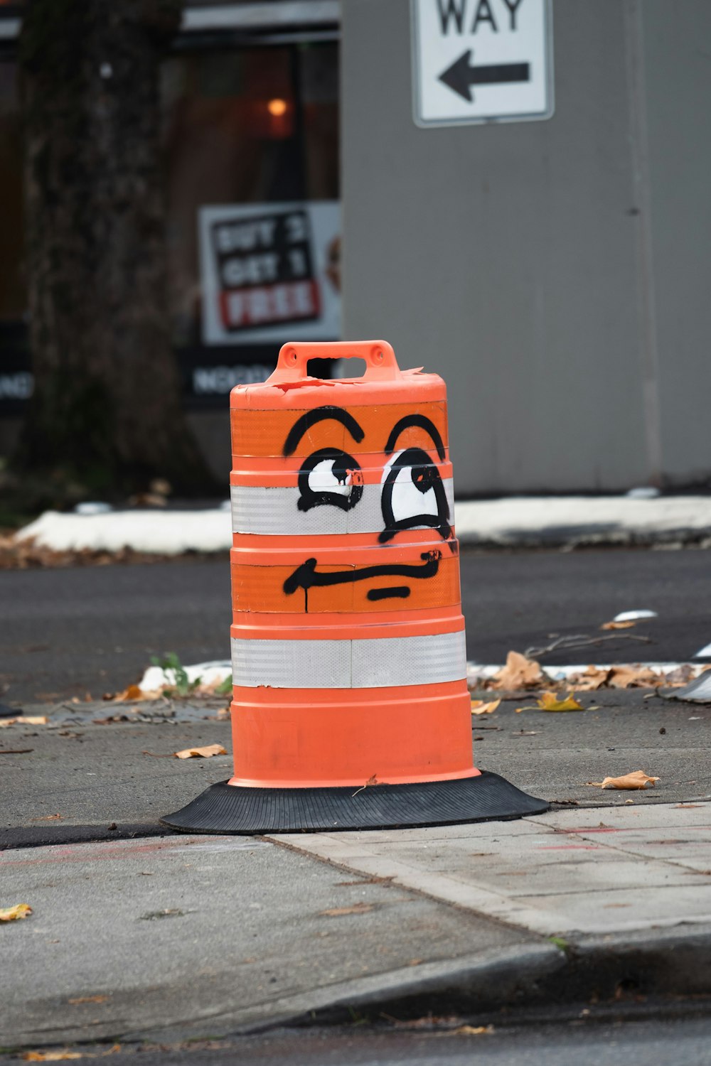 a traffic cone with a face drawn on it
