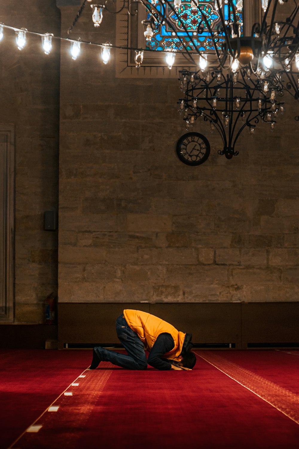 a person kneeling down on a red carpet