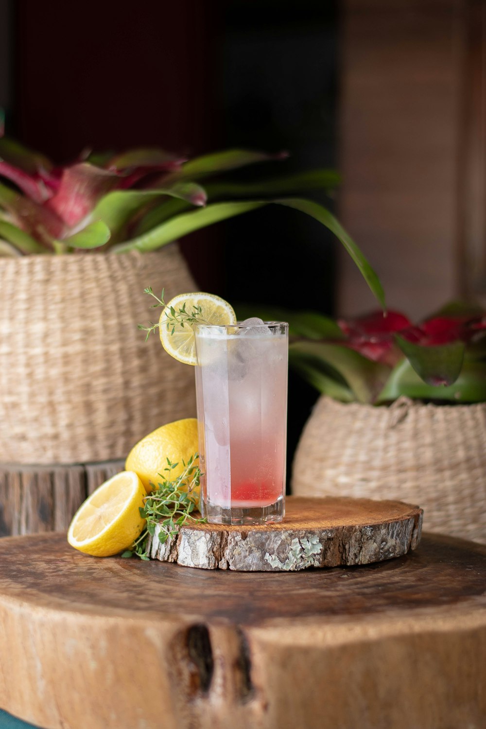 a glass of lemonade sitting on top of a wooden table