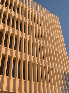 Elegant modern building facade with deep blue and gold accents under soft natural light.