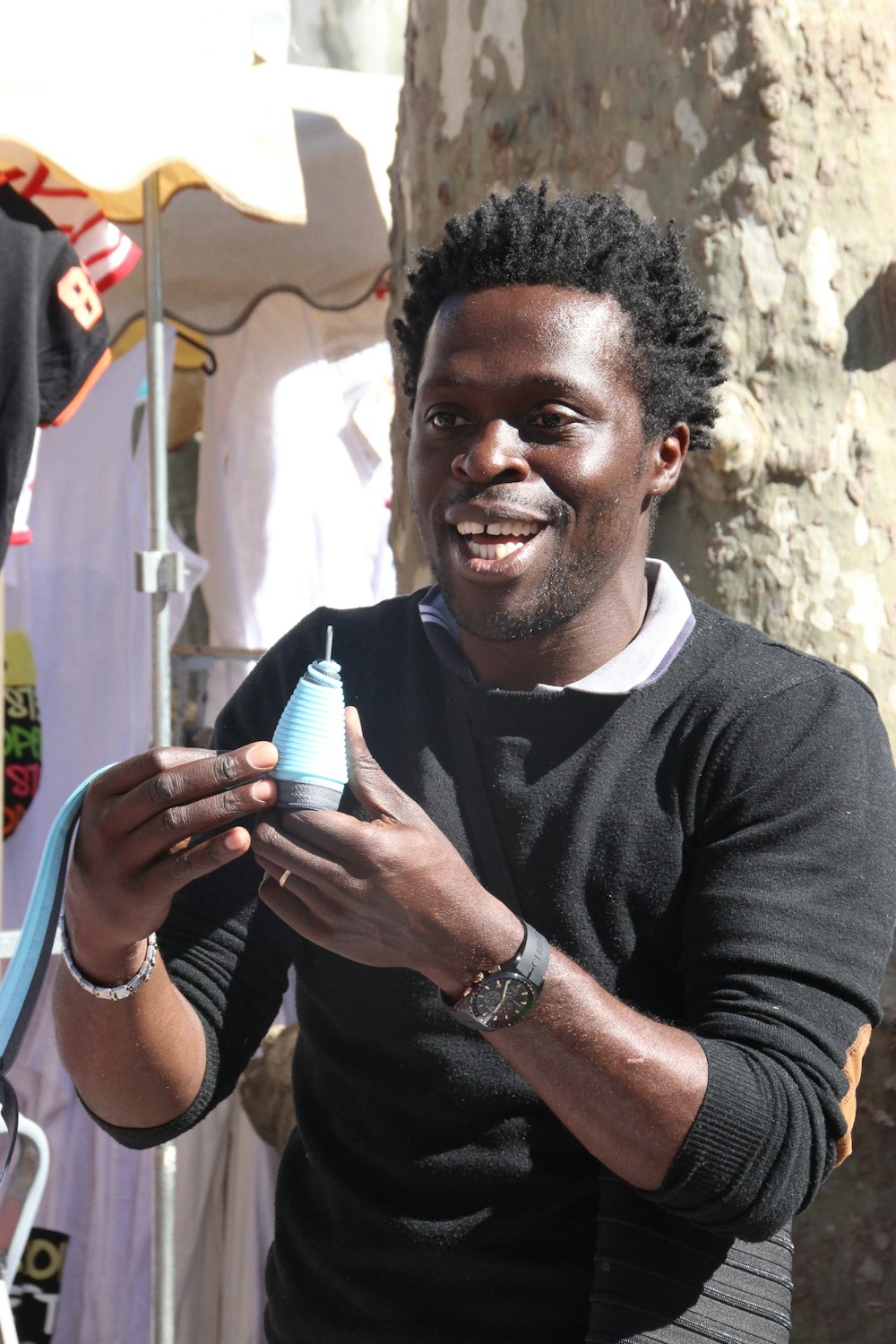 a man is holding a baby bottle and smiling