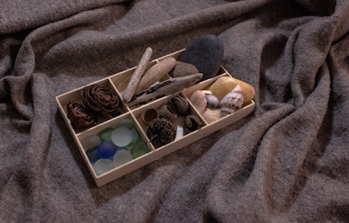 A variety of ecostash boxes stacked neatly, showcasing different styles and sizes in a cozy home setting.