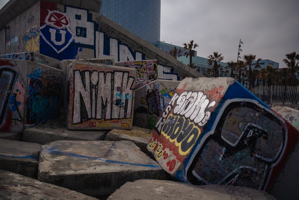 a bunch of graffiti on the side of a building