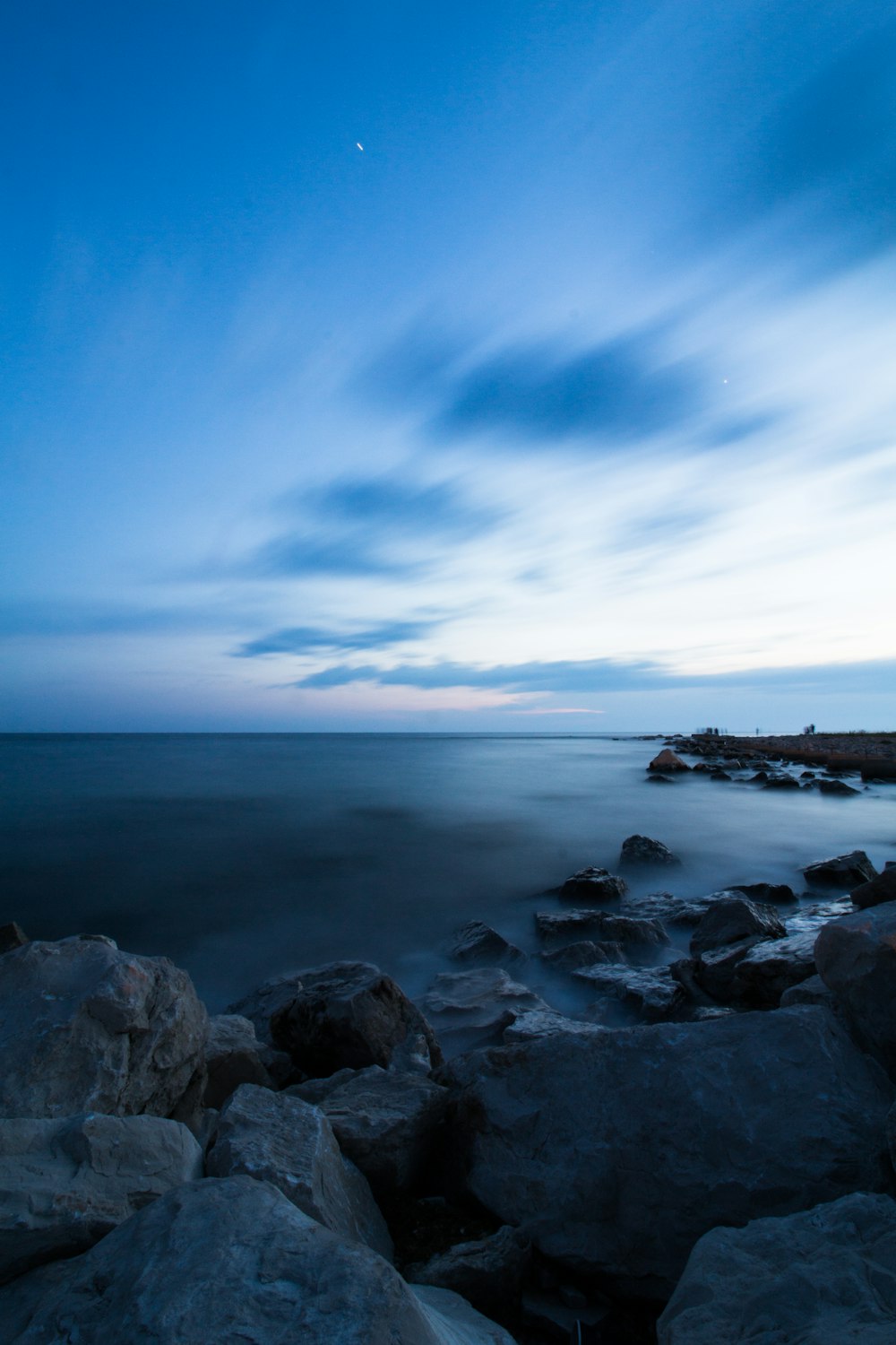 a view of the ocean from a rocky shore