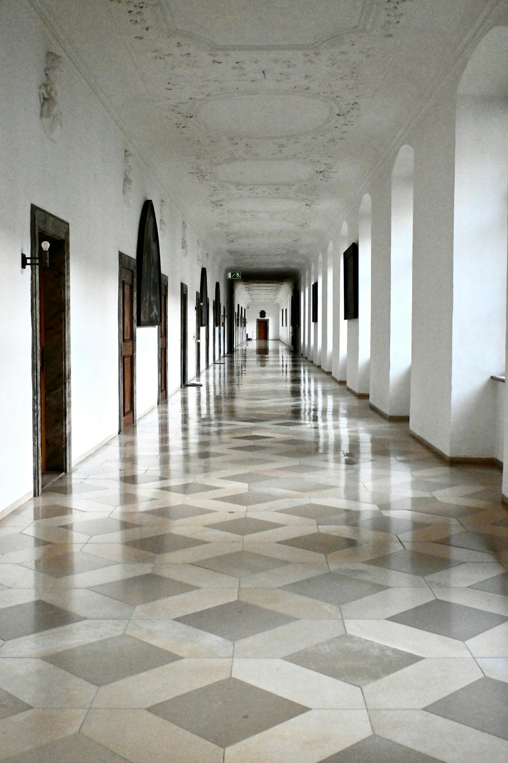 a long hallway with tiled floors and doors