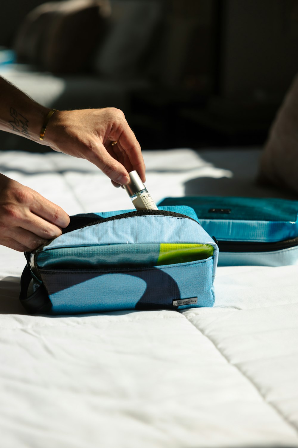 a person putting a toothbrush in a bag