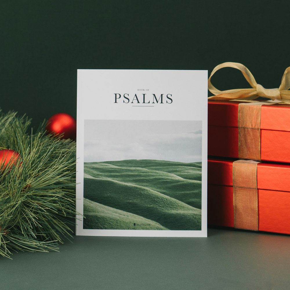 a christmas card with a picture of a green mountain