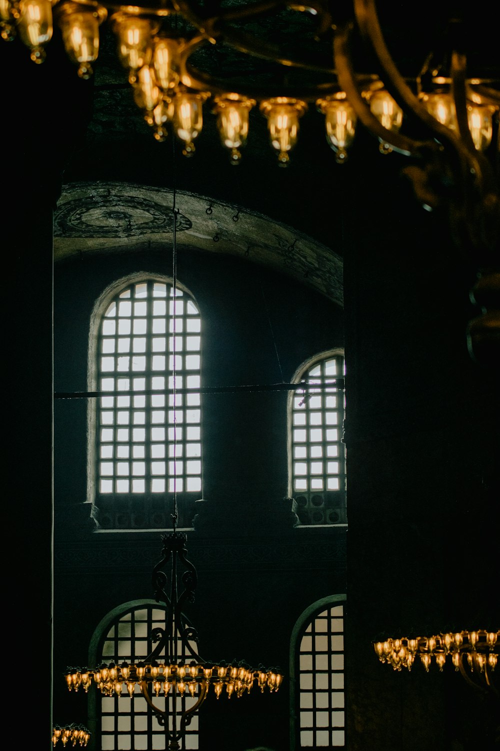 a chandelier hanging from the ceiling in a dark room