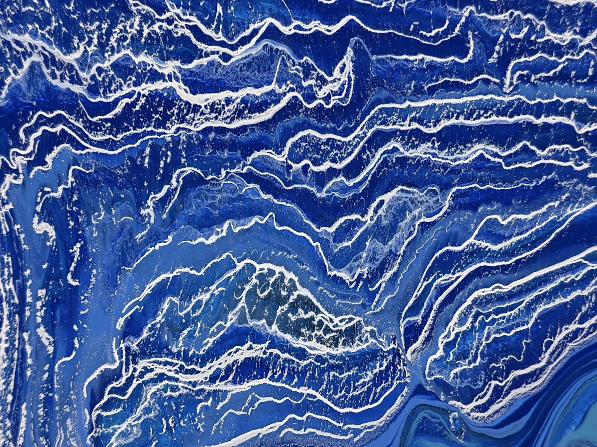 Blue and teal epoxy resin wall piece with swirled pigment
