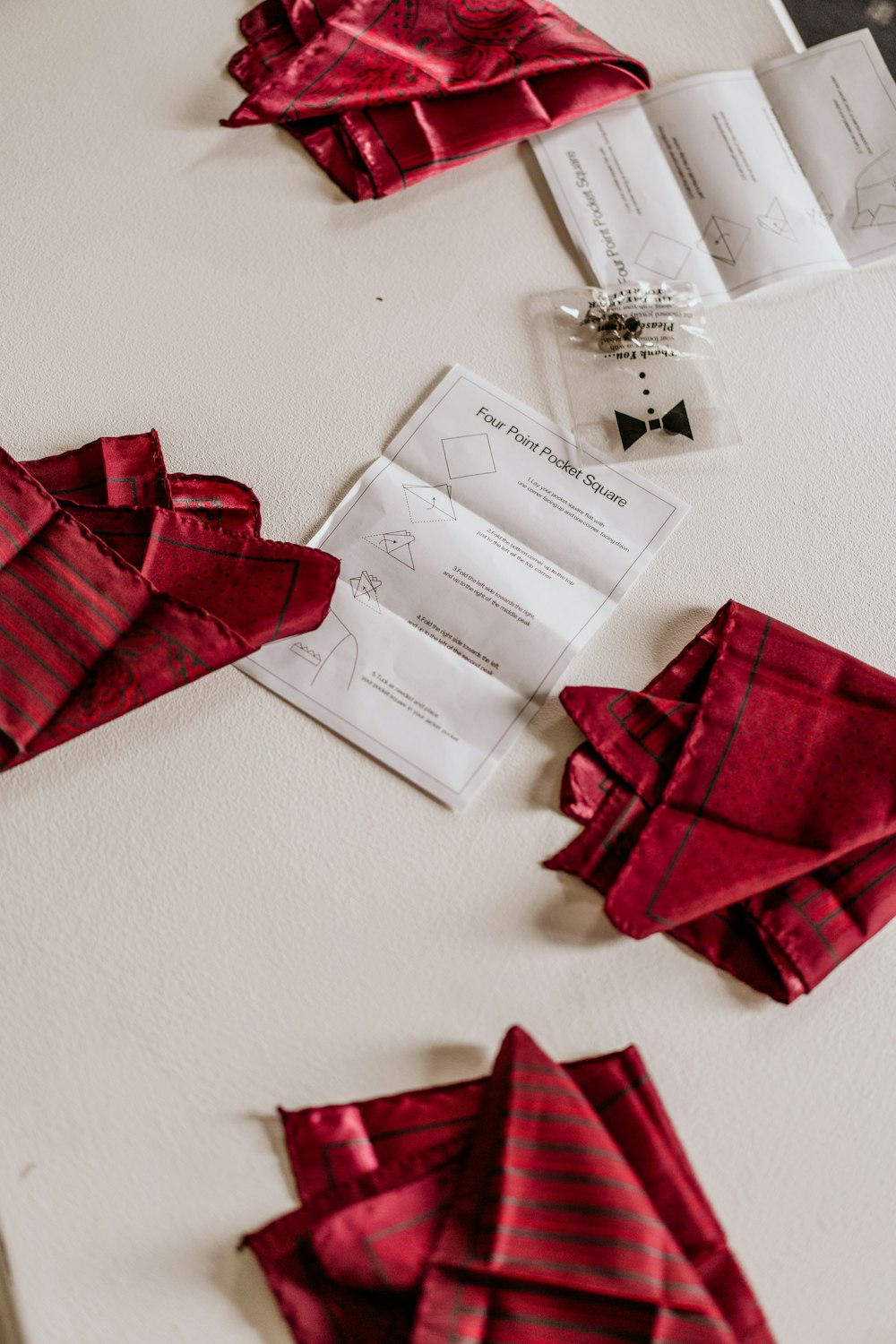 a table topped with red napkins and cards