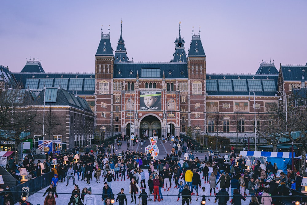 a large group of people standing in front of a building