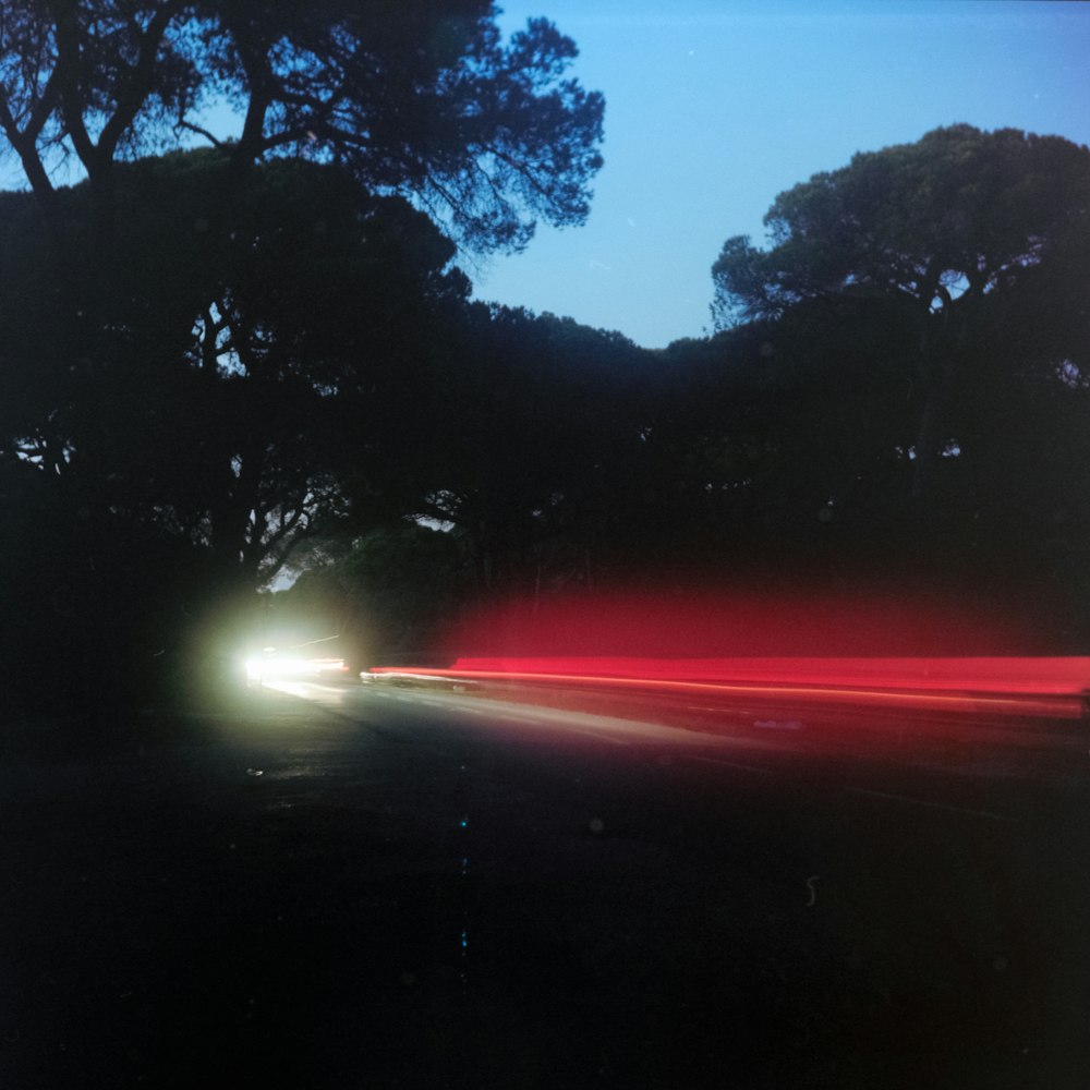 a car driving down a road at night