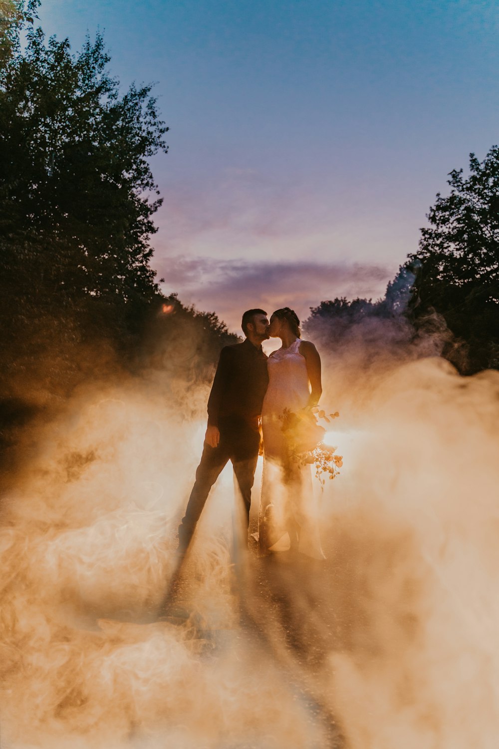 a man and a woman standing on a dirt road