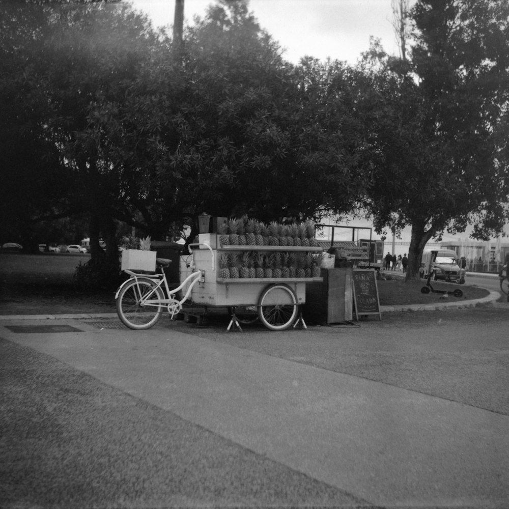 a bike parked on the side of a road next to a truck