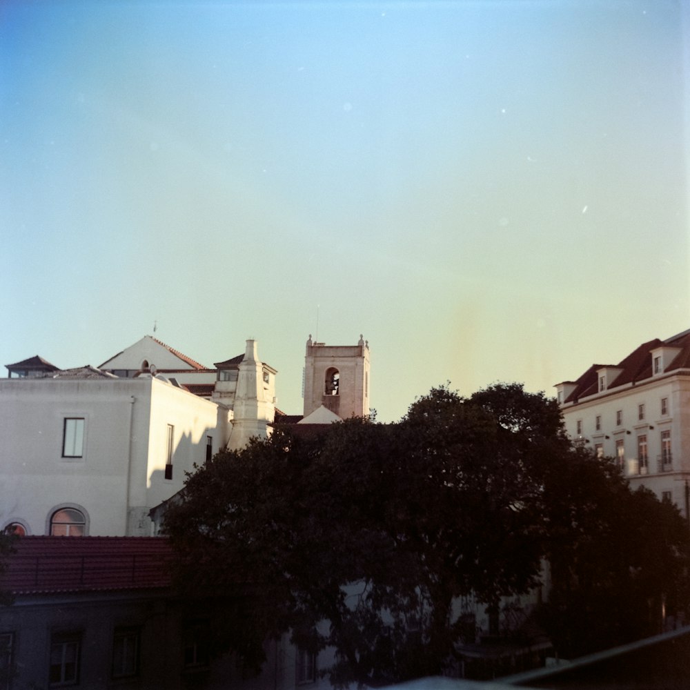 an old photo of a city with a clock tower