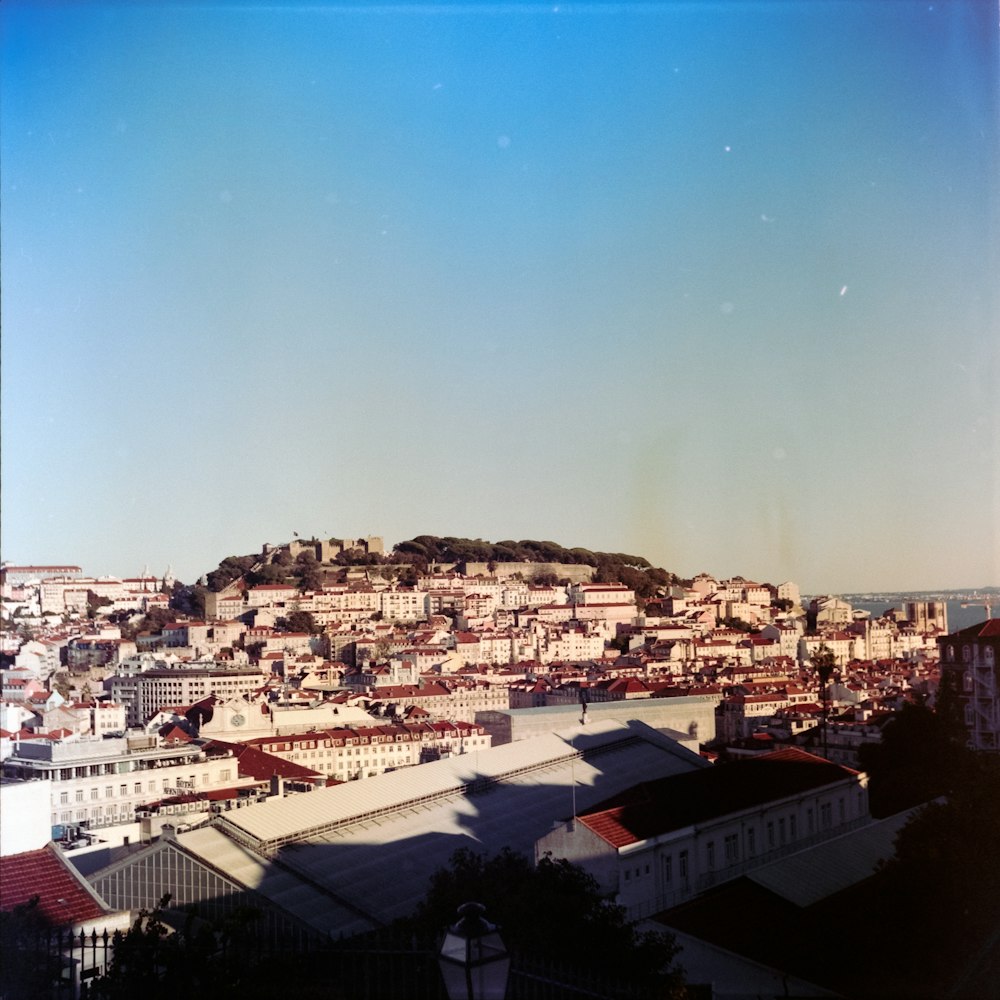 a view of a city with a hill in the background