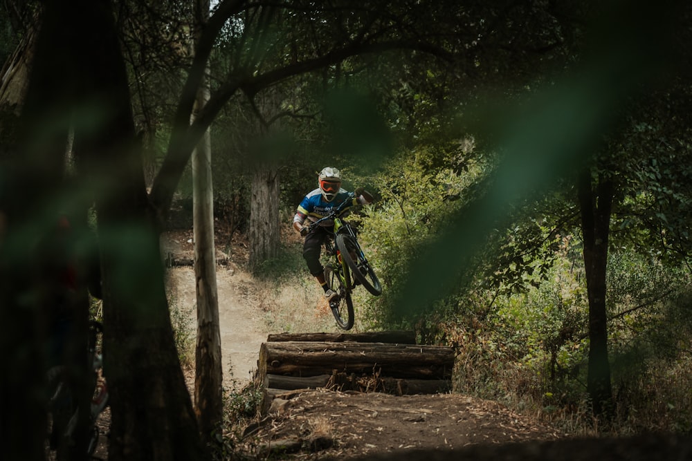 a man riding a bike down a dirt trail