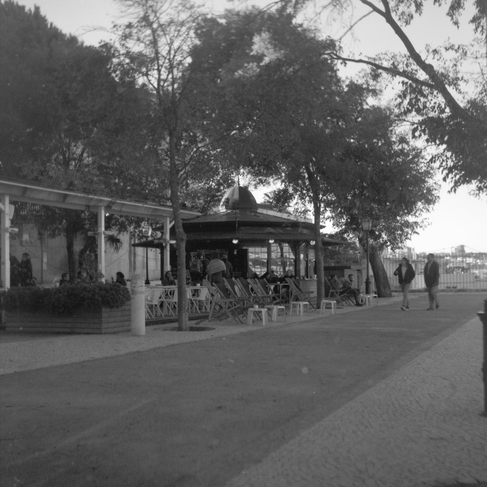 a black and white photo of a bus stop