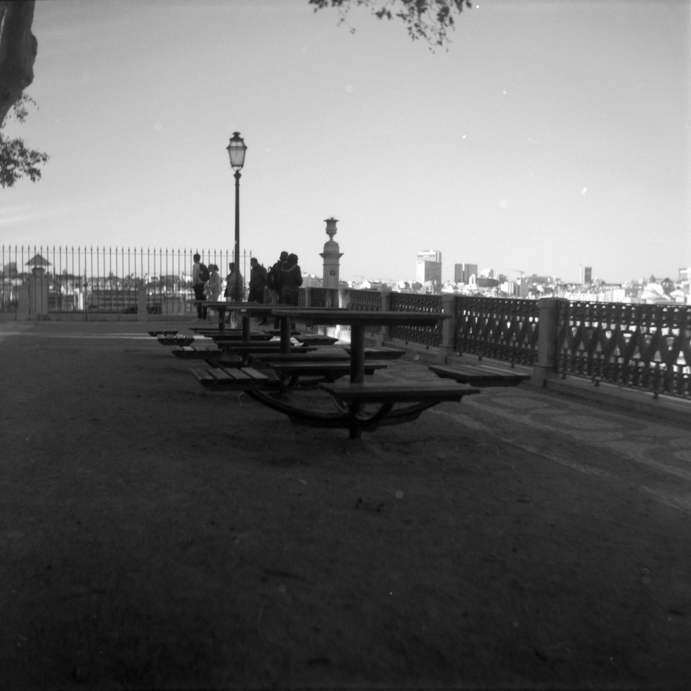 a black and white photo of a park with benches