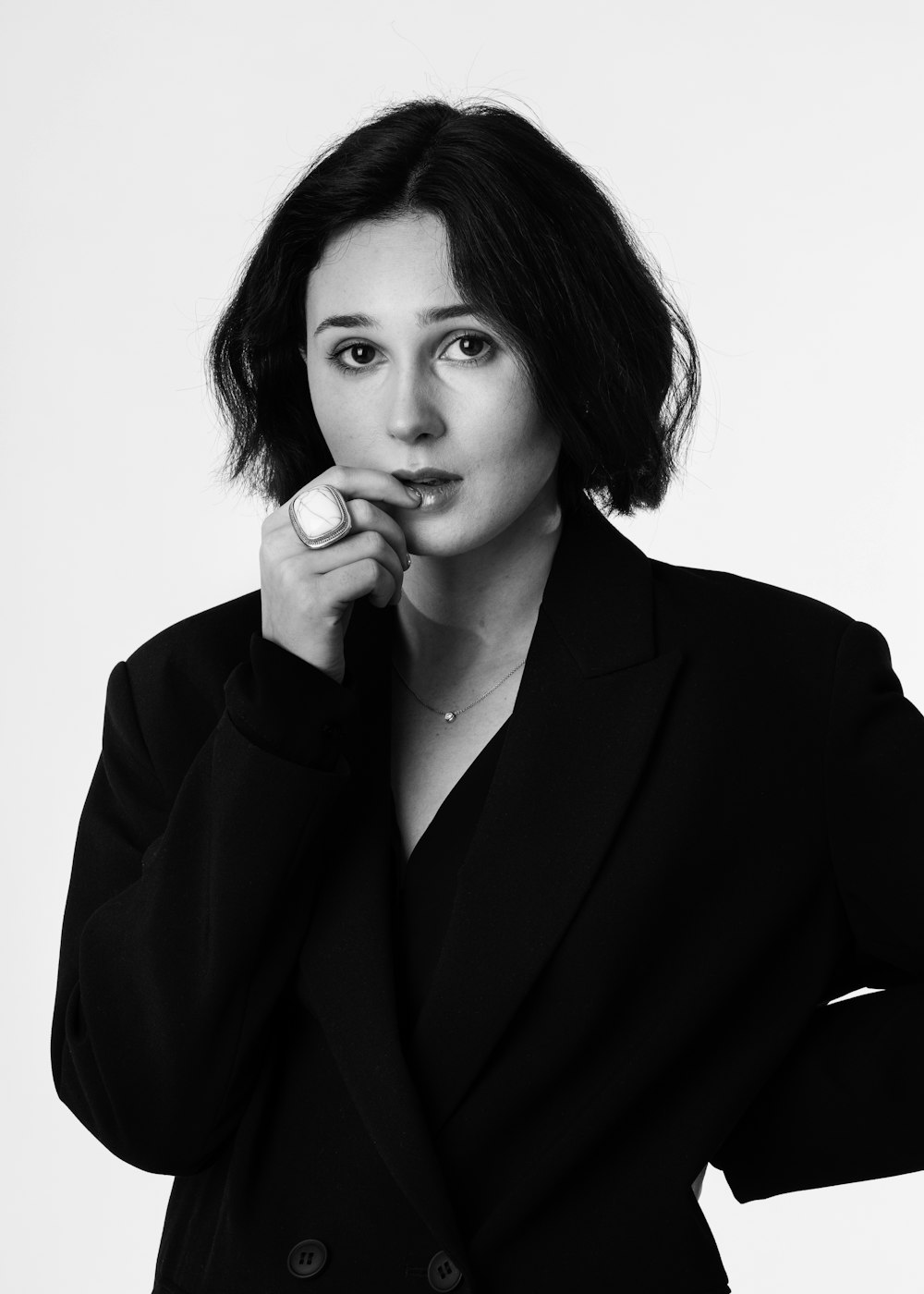 a black and white photo of a woman in a suit