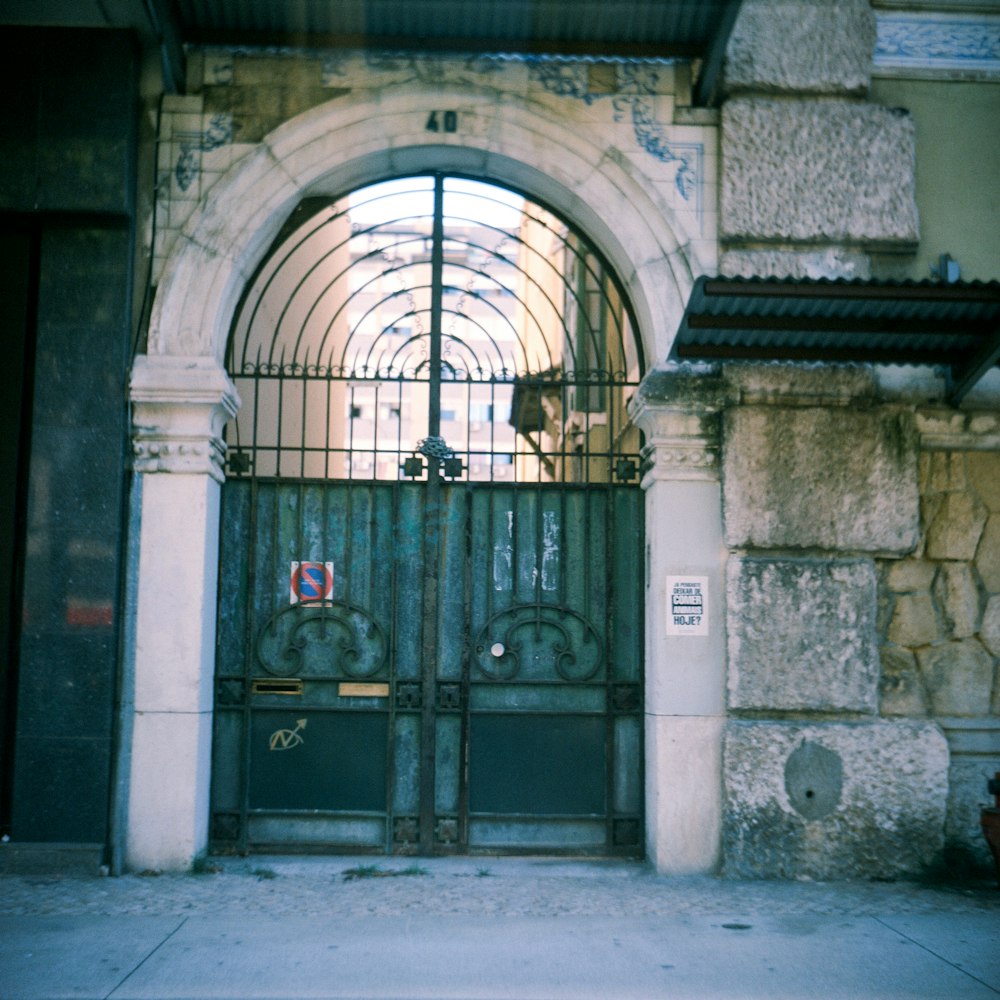 a gated entrance to a building with a clock on it
