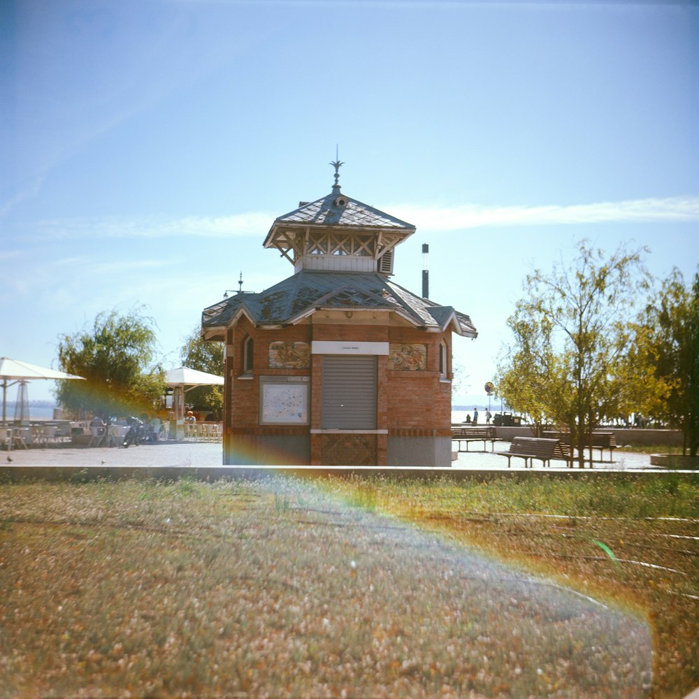 a small building with a clock tower on top of it