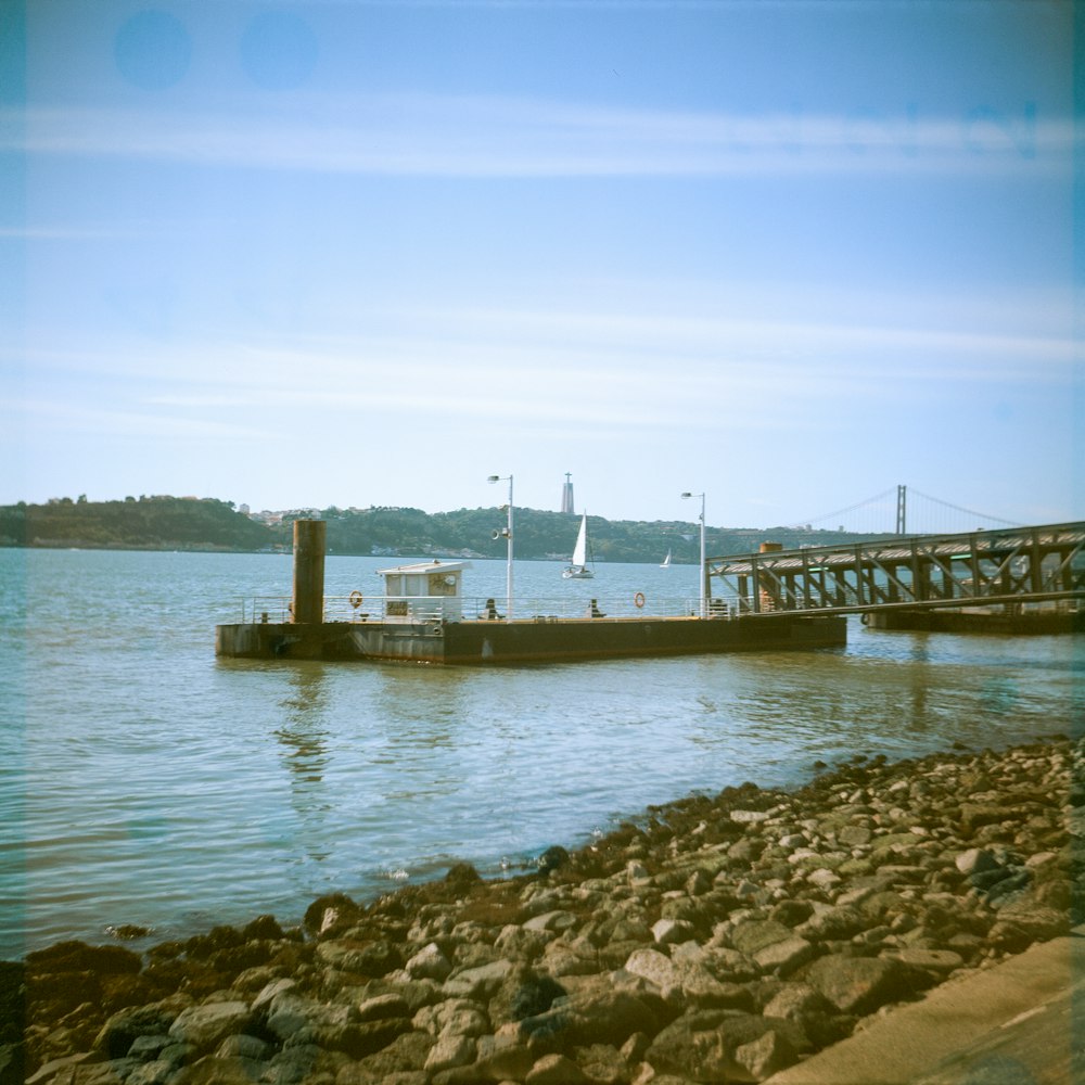 a boat is docked at a pier on the water