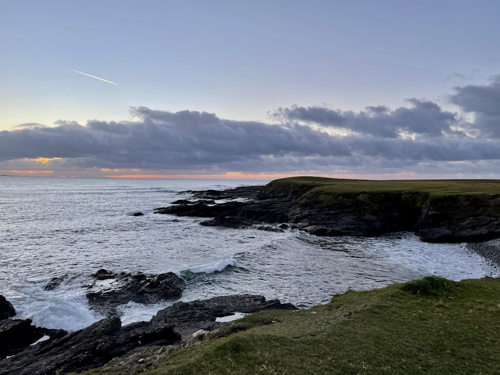 a lighthouse on a cliff overlooking the ocean