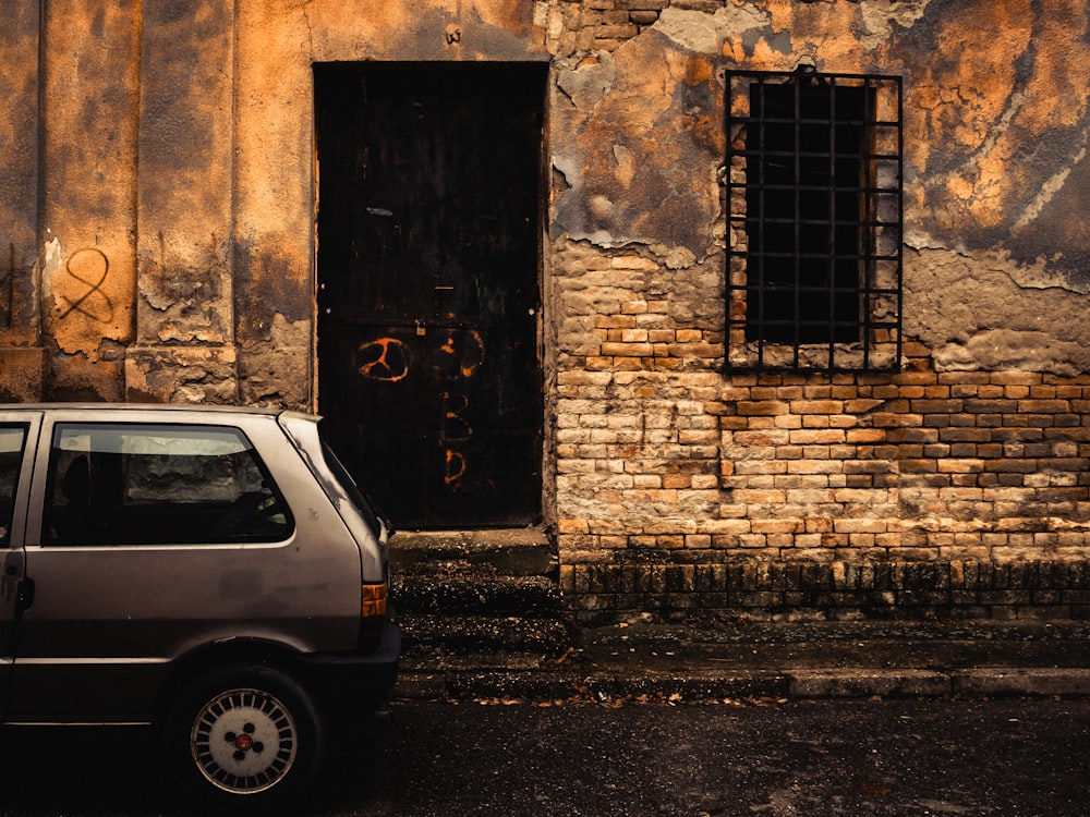 a small car parked in front of a building