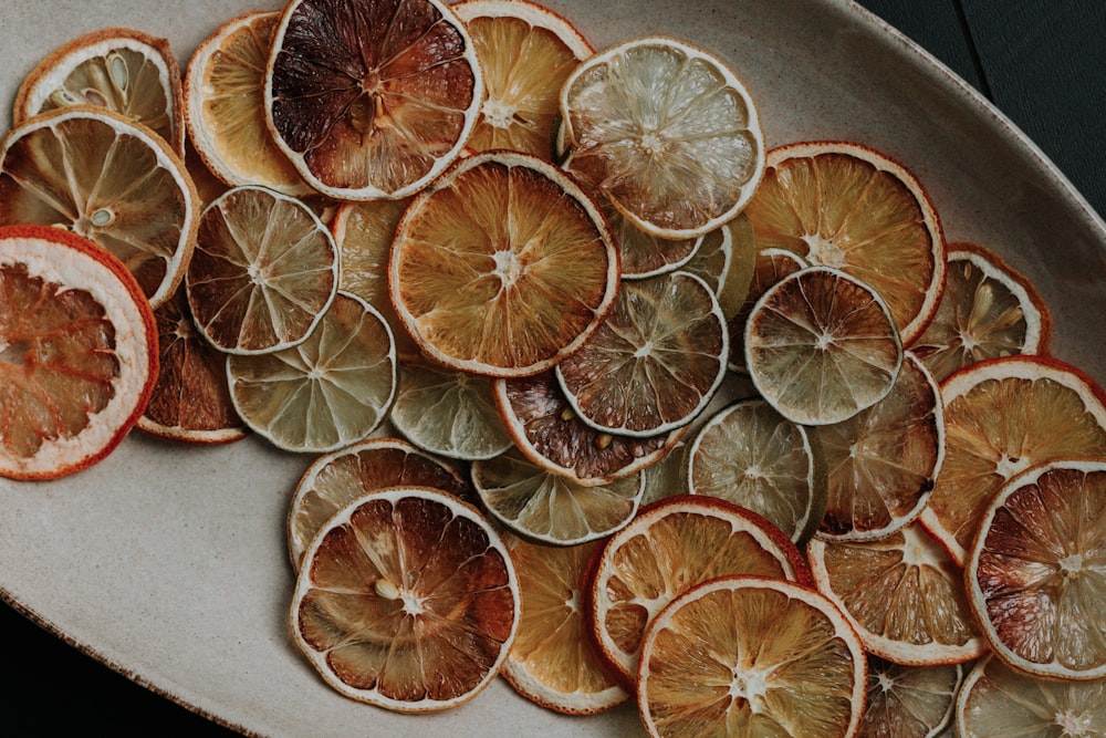 a white plate topped with sliced oranges on top of a table