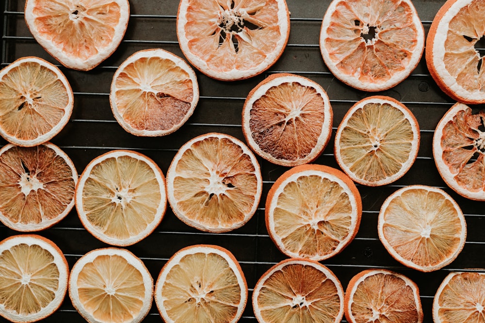 a bunch of oranges that are on a grill