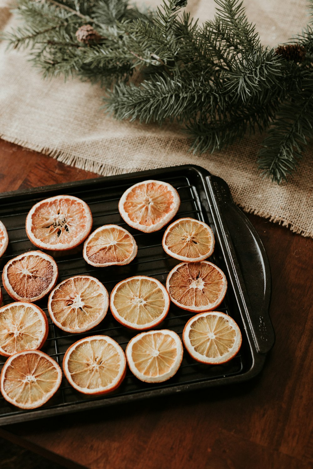 a tray of sliced oranges sitting on top of a wooden table