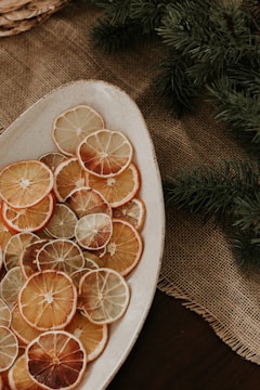 a plate of sliced oranges on a table