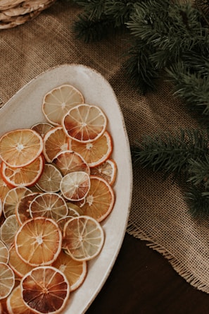 a plate of sliced oranges on a table