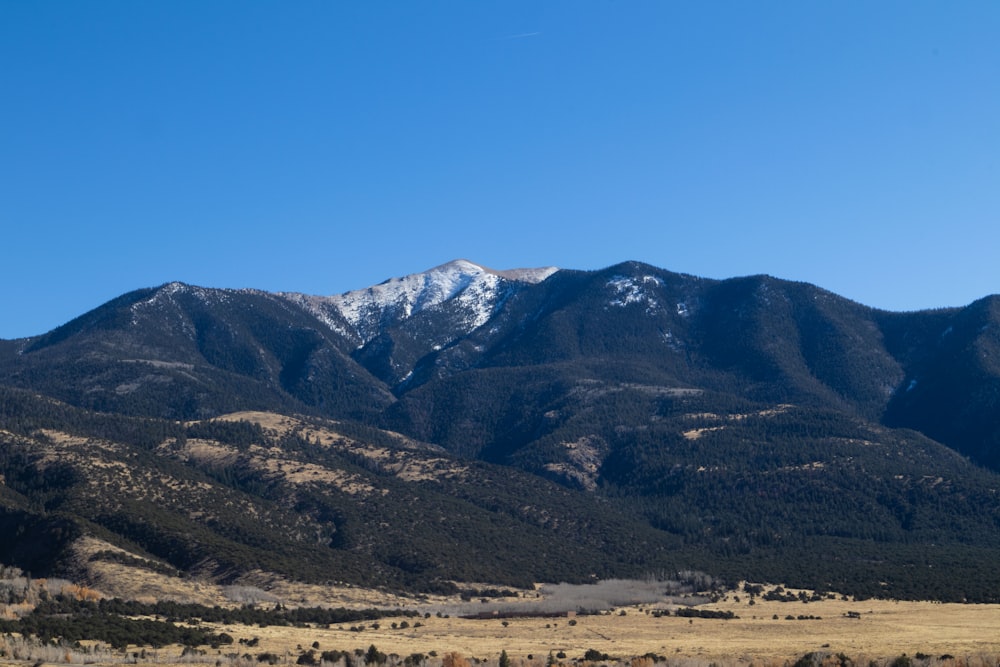 a view of a mountain range with snow on the top