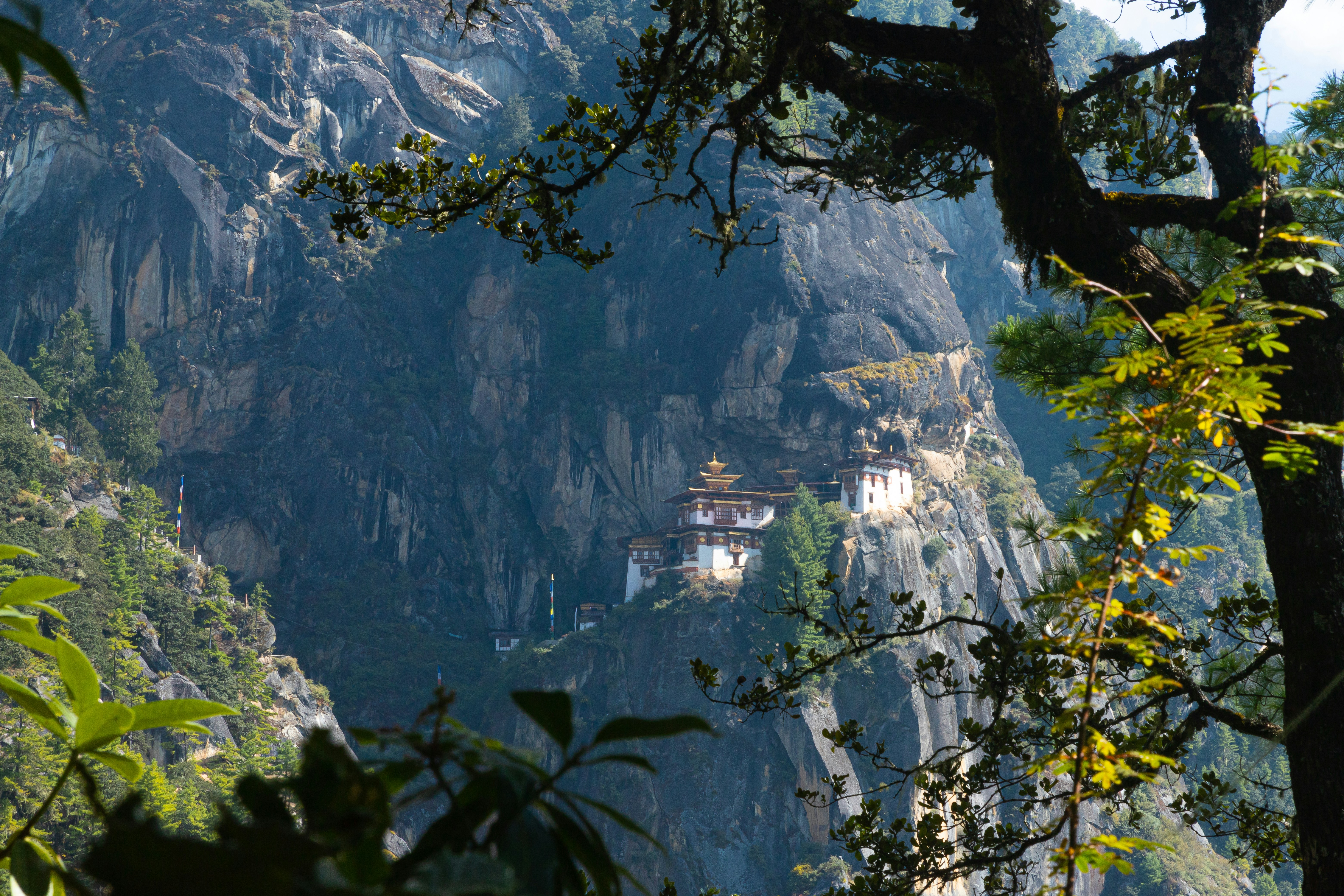 a view of a mountain with a building on top of it, Built in the 8th century by Guru Rinpoche, Taktshang (Tiger