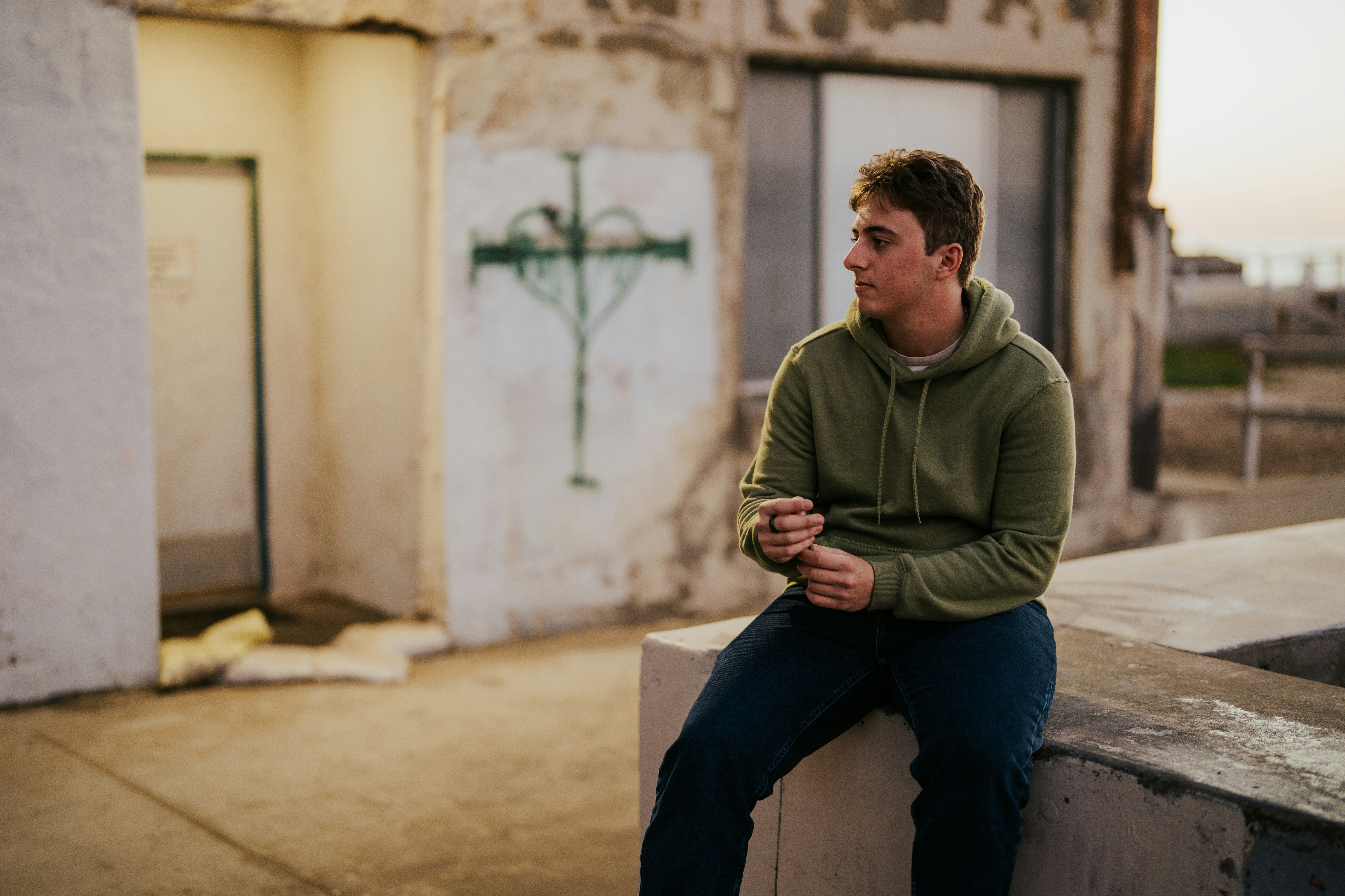 a man sitting on a cement bench in front of a building