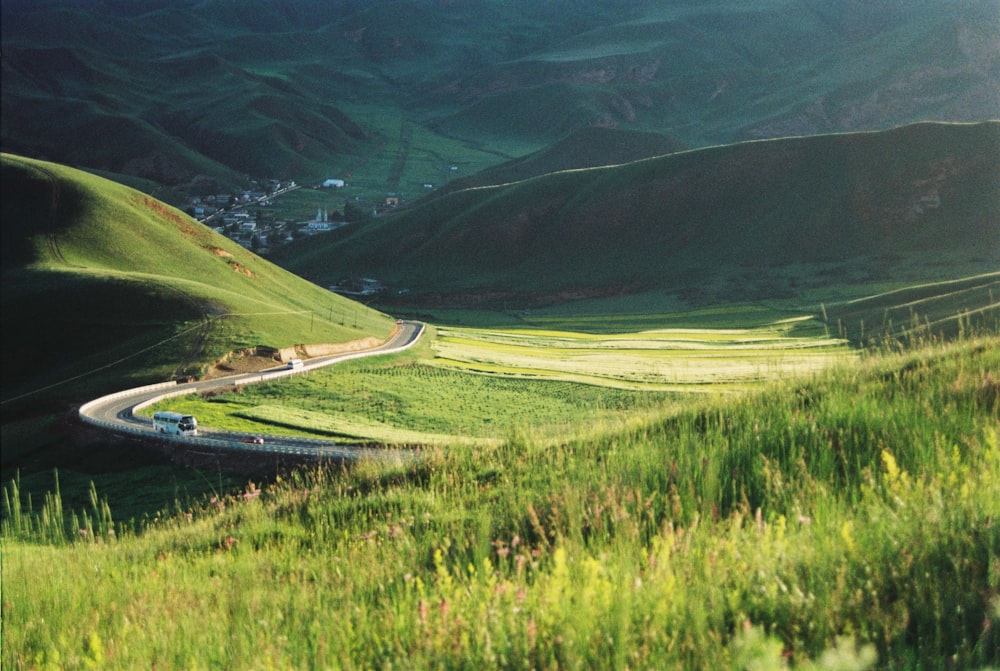 a car driving down a winding road in the mountains