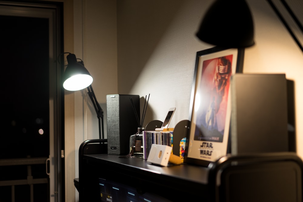 a desk with a lamp and a picture on it