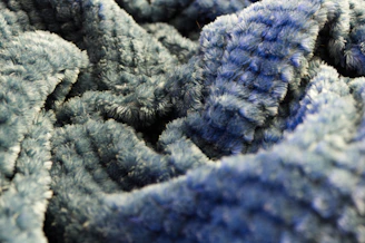 Close-up of a blue fluffy texture with soft shadows highlighting its depth.