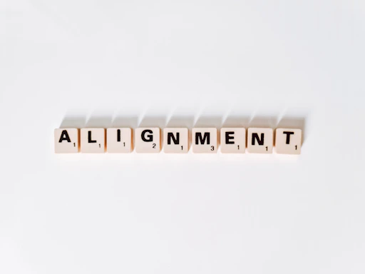 the word alignmentment spelled with scrabble letters