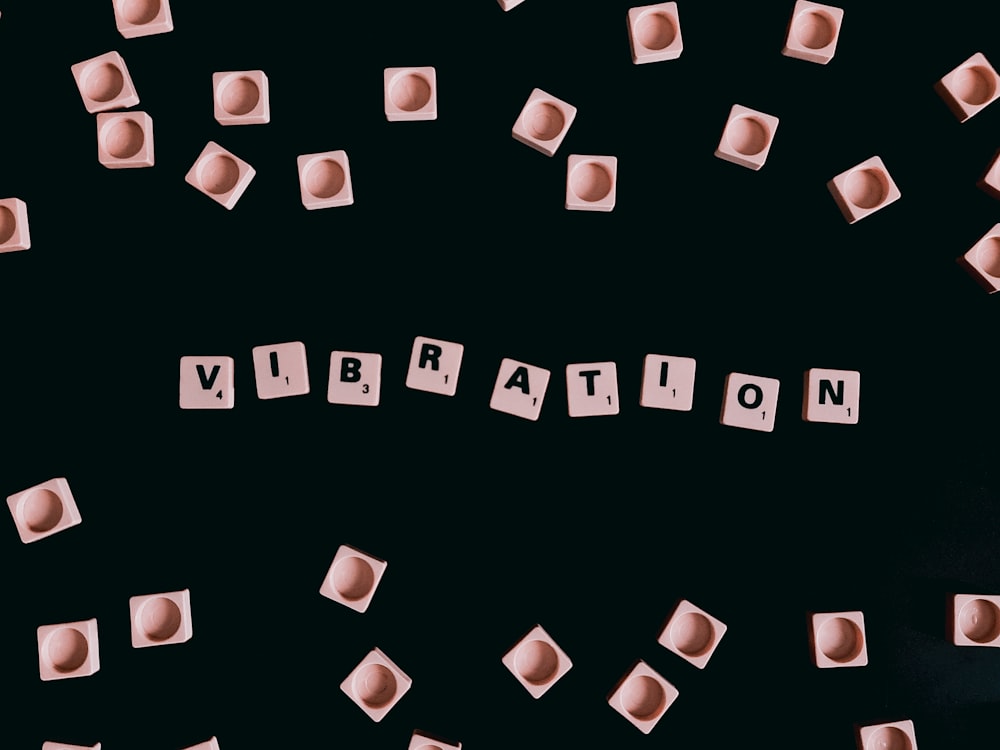 a black background with cubes that spell out the word vibration
