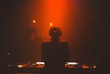 a woman standing in front of a dj set