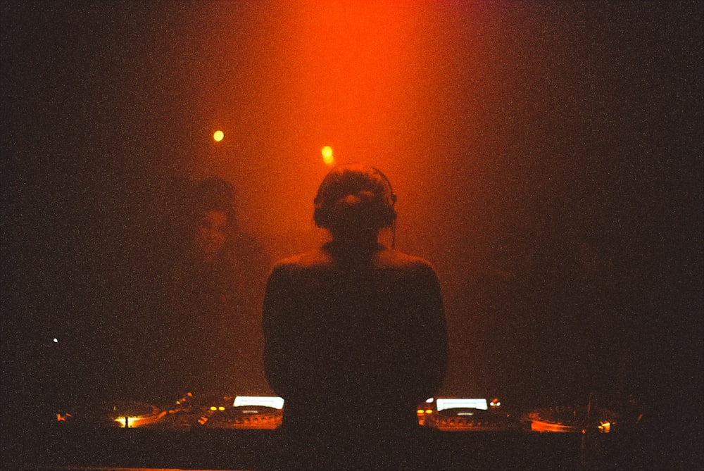 a woman standing in front of a dj set