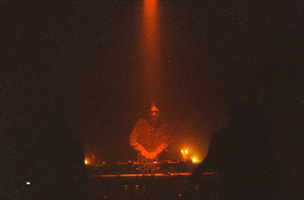 a dj mixing on a stage at night