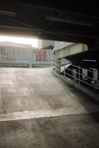 a person riding a skateboard under a bridge