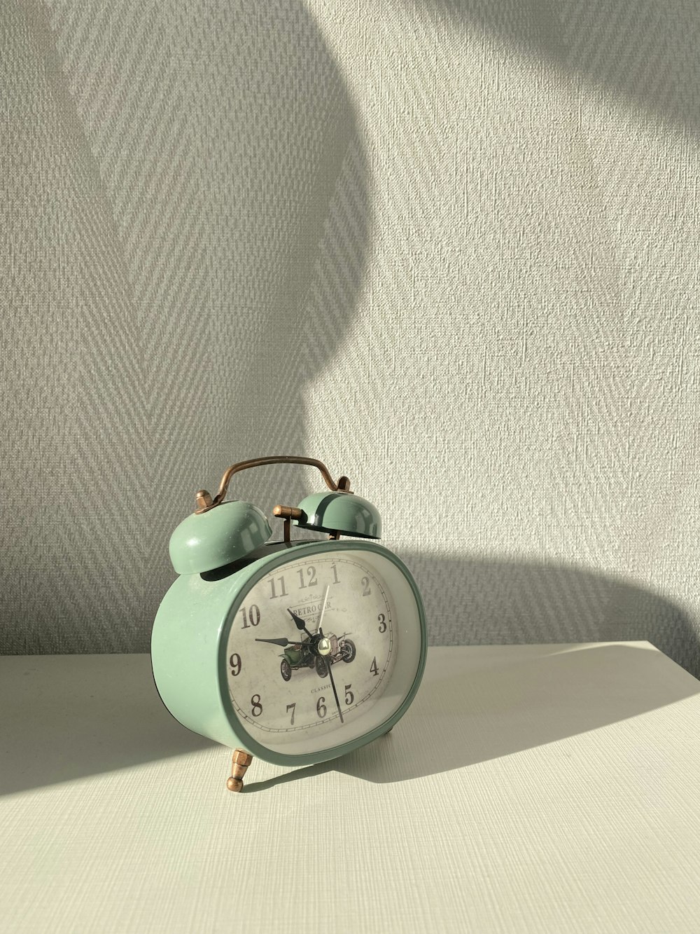 a green alarm clock sitting on top of a table