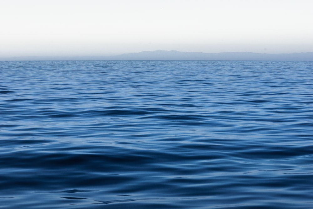 a large body of water with a small island in the distance