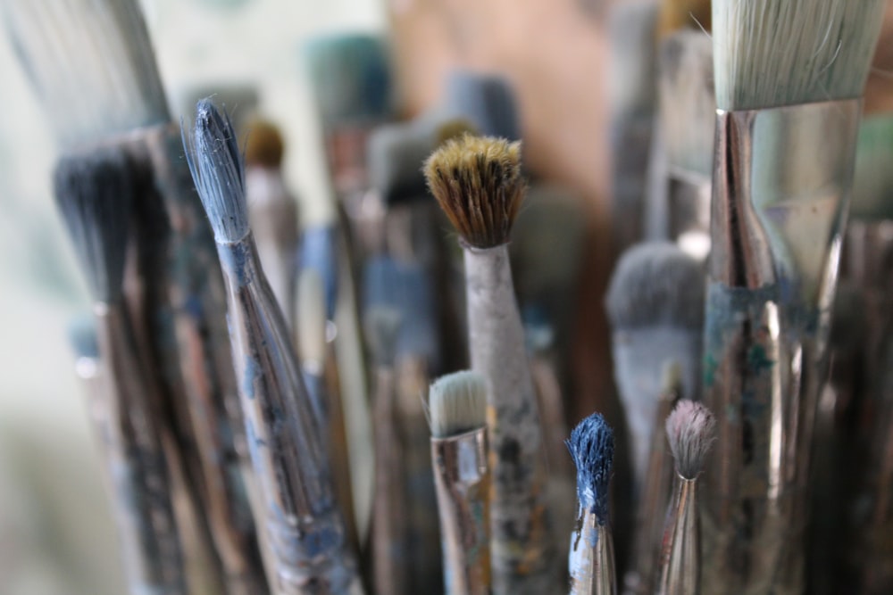 a close up of many brushes in a cup
