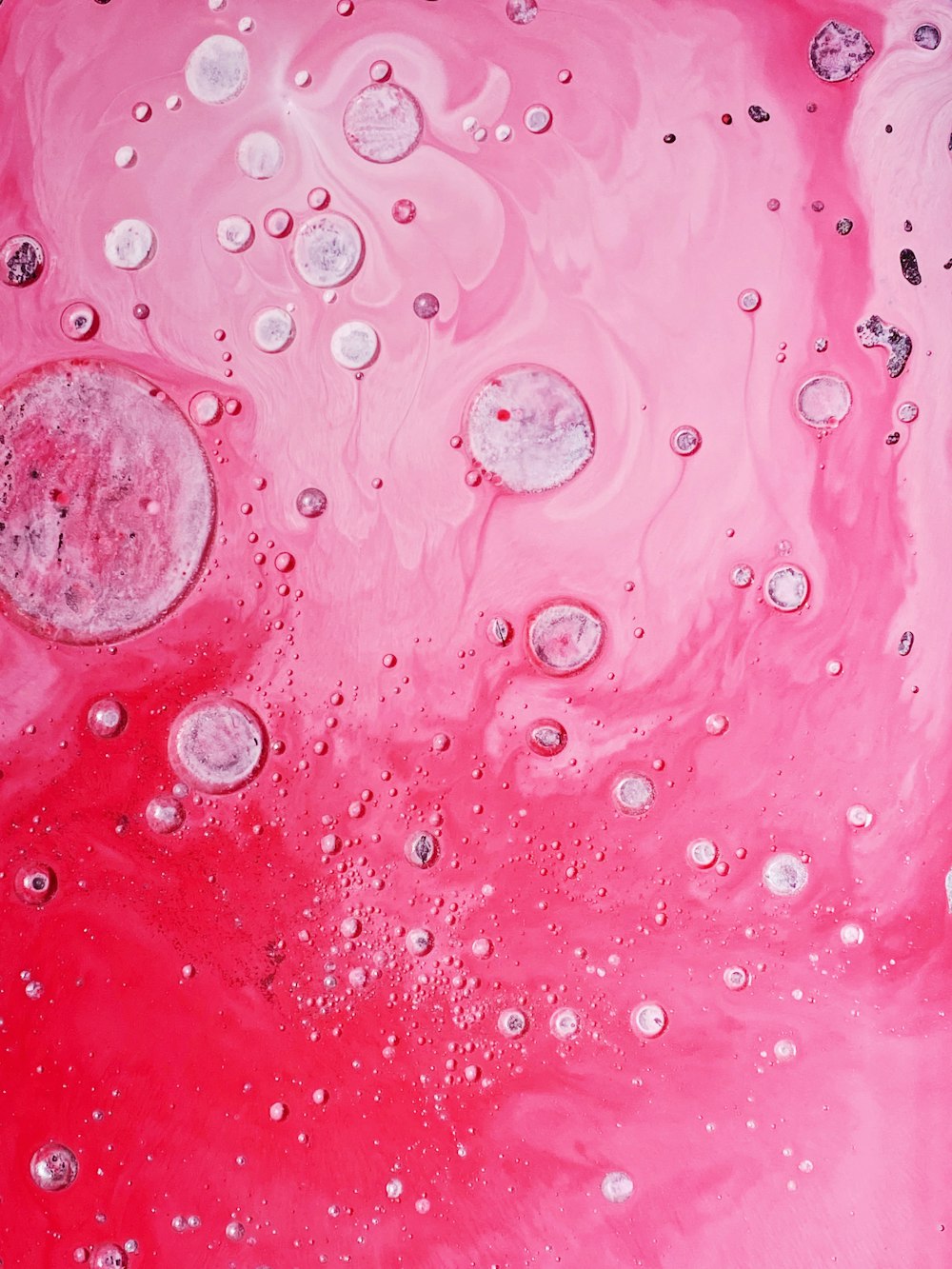 a close up of a pink liquid with bubbles